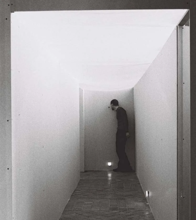 part of the Leaving Room installation - the entrance corridor leading to the exhibition: drywall, plug-in lamps, notebooks and fragments of